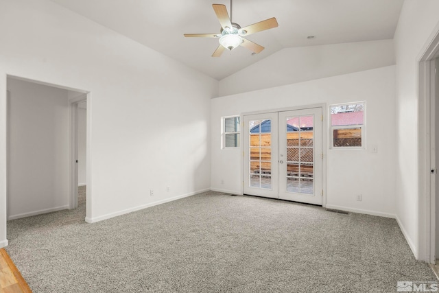 spare room with carpet flooring, ceiling fan, french doors, and vaulted ceiling