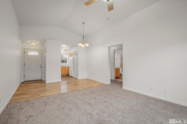 unfurnished living room with ceiling fan, light hardwood / wood-style floors, and lofted ceiling