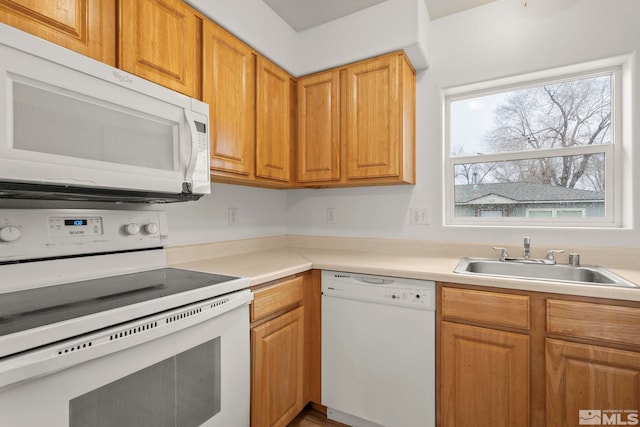 kitchen featuring white appliances and sink