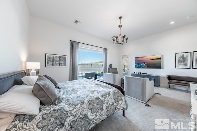 carpeted bedroom with a notable chandelier