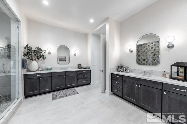 bathroom with a shower with door and vanity