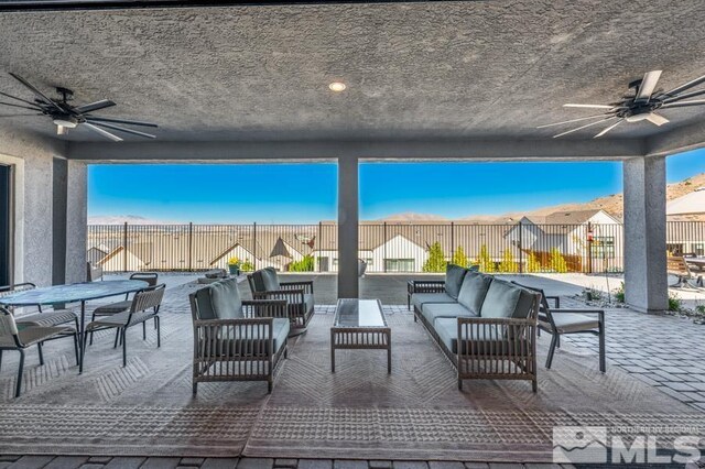 view of patio with ceiling fan and an outdoor living space