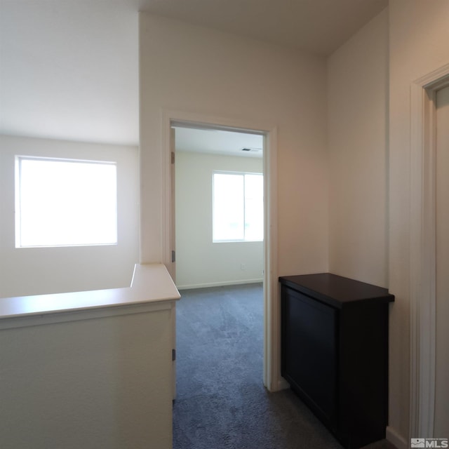 hallway with dark carpet