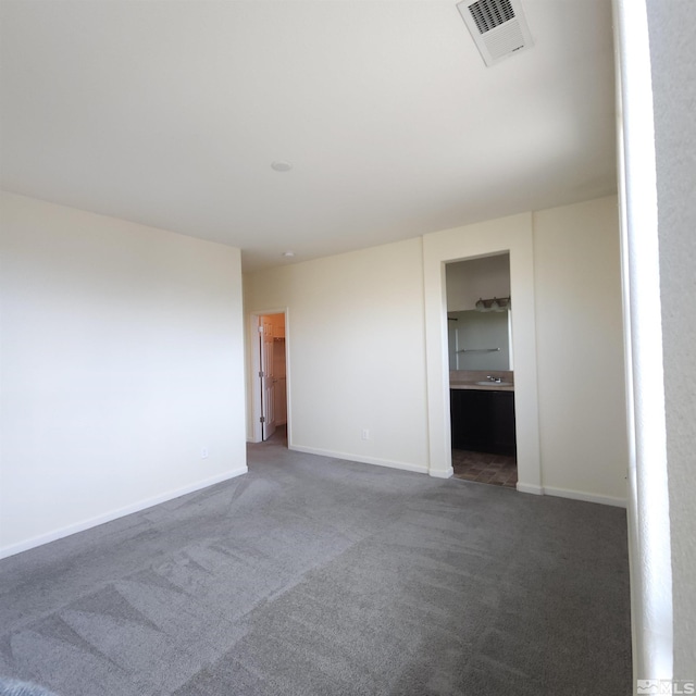 carpeted empty room featuring sink