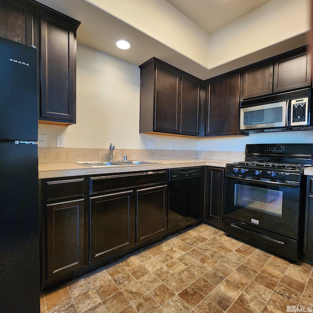 kitchen featuring dark brown cabinetry, sink, and black appliances