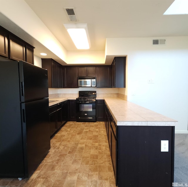 kitchen with kitchen peninsula, dark brown cabinets, and black appliances