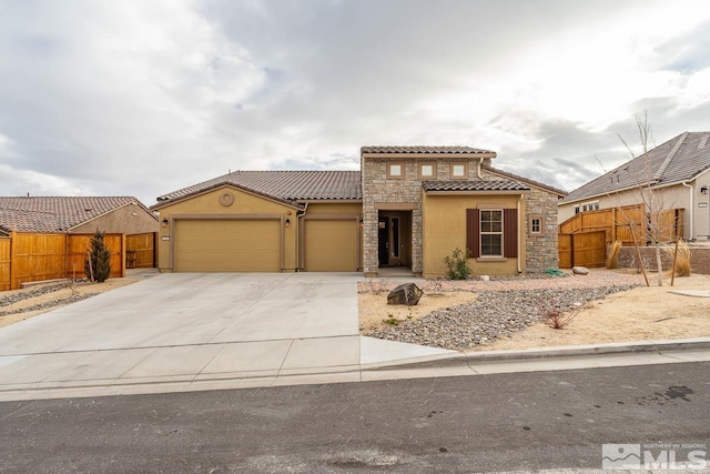 mediterranean / spanish-style home with a garage