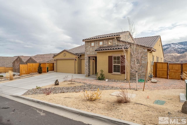 view of front of property with a mountain view and a garage