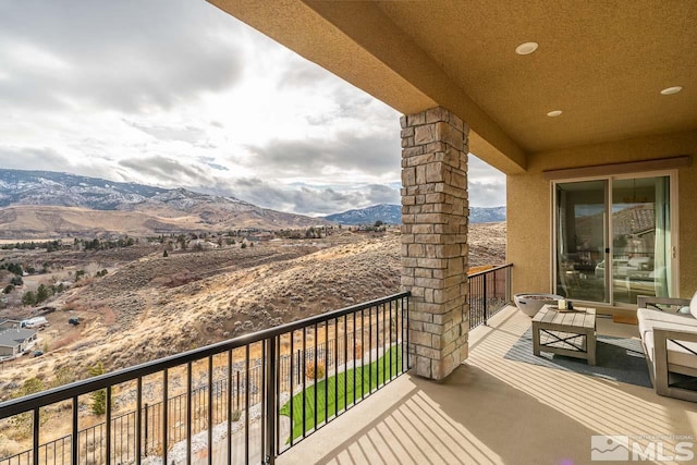 balcony featuring a mountain view