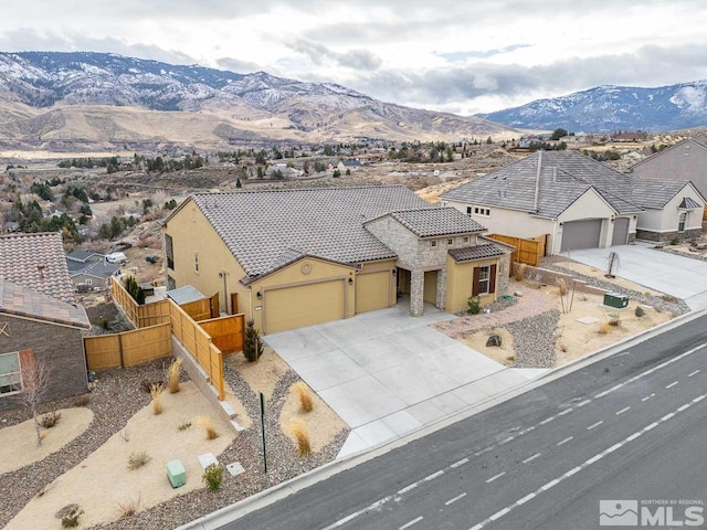 view of front facade with a mountain view and a garage