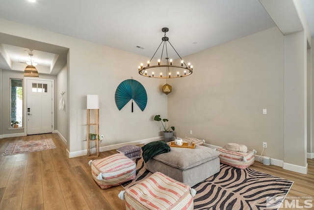 interior space with hardwood / wood-style floors and an inviting chandelier