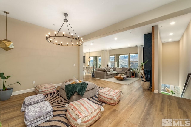 living room with wood-type flooring and an inviting chandelier