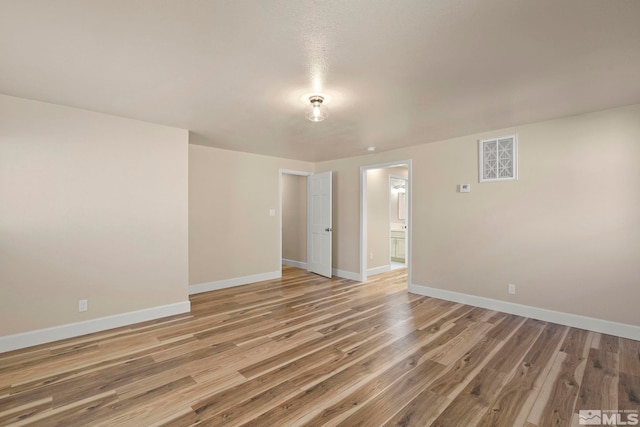 spare room with hardwood / wood-style floors