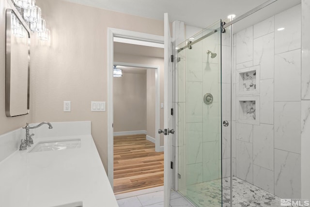 bathroom featuring hardwood / wood-style floors, vanity, and an enclosed shower