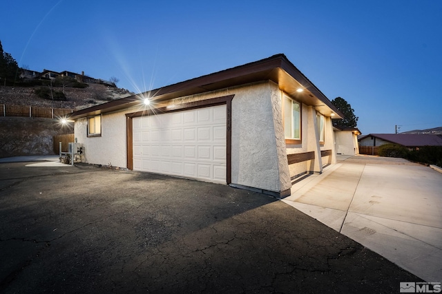 property exterior at dusk with a garage