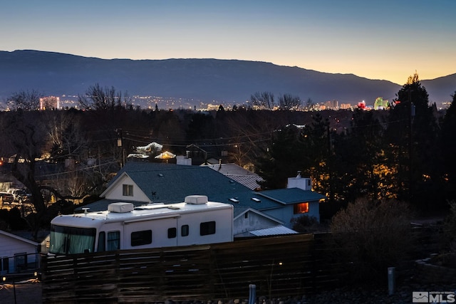 aerial view at dusk featuring a mountain view