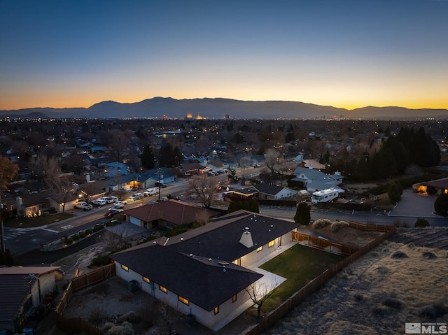 aerial view at dusk featuring a mountain view