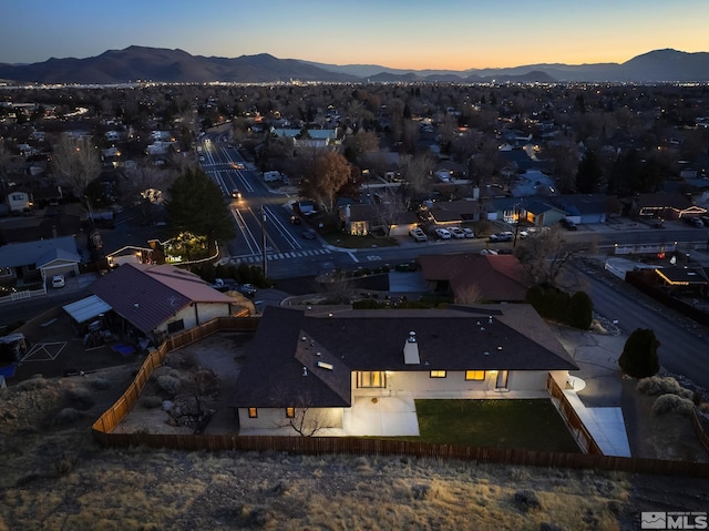 aerial view at dusk featuring a mountain view