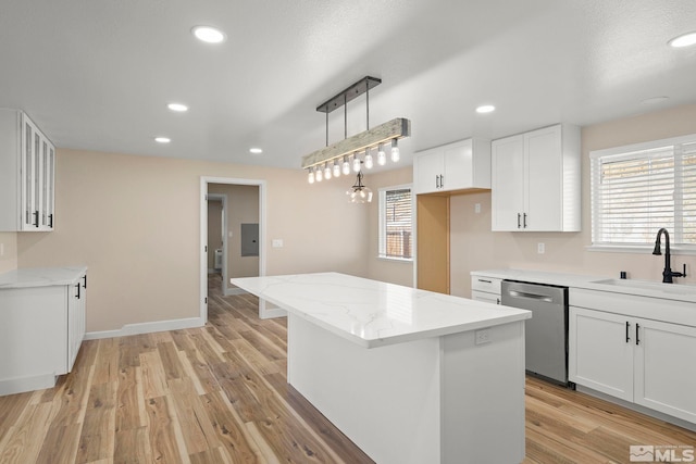 kitchen with white cabinets, dishwasher, a kitchen island, and sink