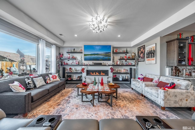 living room featuring hardwood / wood-style flooring and an inviting chandelier