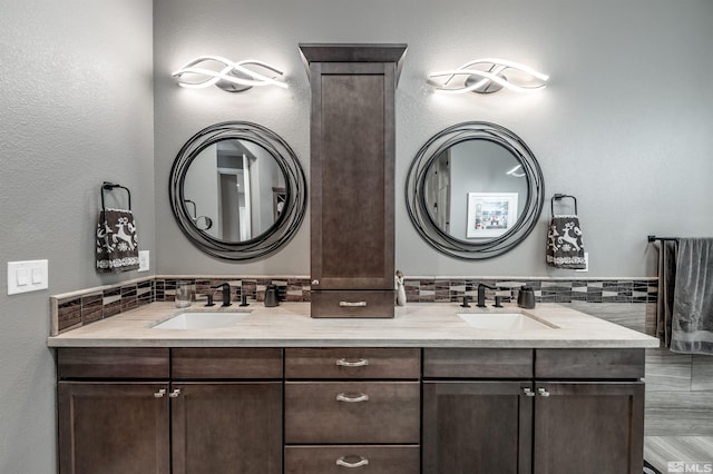 bathroom featuring decorative backsplash and vanity