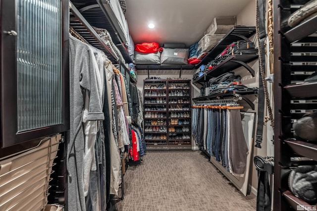 walk in closet with carpet floors