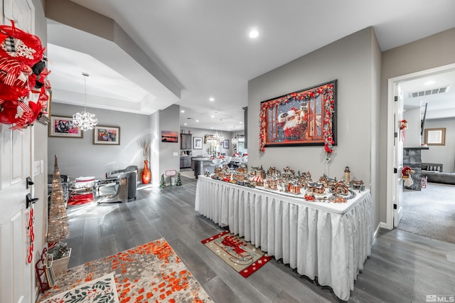 hall featuring dark hardwood / wood-style floors and a notable chandelier