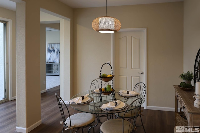 dining space with dark wood-type flooring