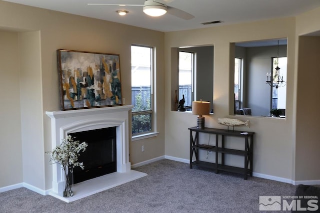 unfurnished living room featuring ceiling fan and carpet floors