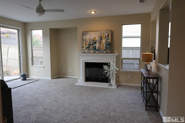 carpeted living room with ceiling fan