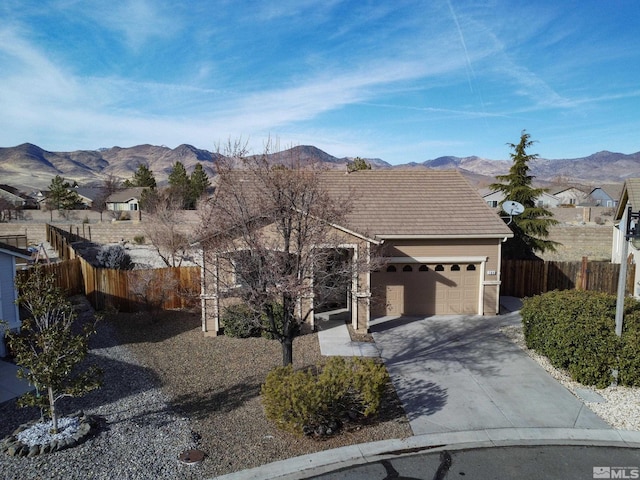 ranch-style home featuring a mountain view and a garage