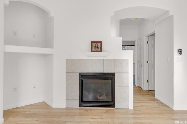 interior details featuring wood-type flooring and a fireplace