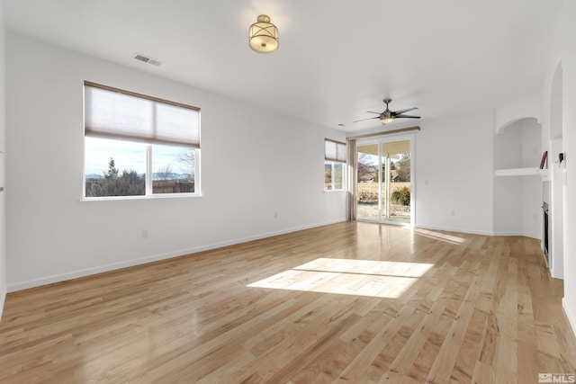 unfurnished living room with ceiling fan and light wood-type flooring