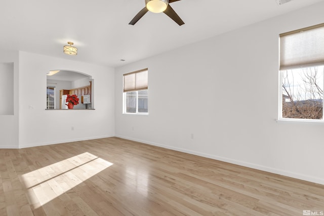 unfurnished room with ceiling fan, light hardwood / wood-style floors, and a wealth of natural light