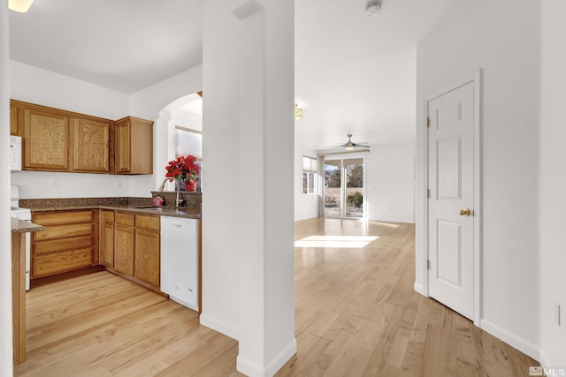 kitchen featuring white appliances, light hardwood / wood-style floors, ceiling fan, and sink