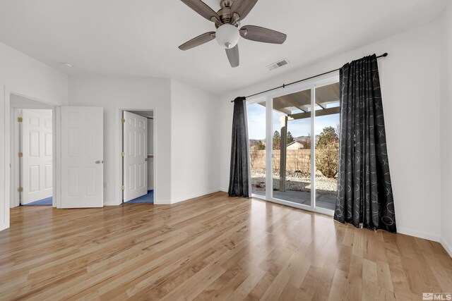 empty room featuring ceiling fan and light wood-type flooring