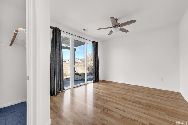 unfurnished room featuring light wood-type flooring and ceiling fan