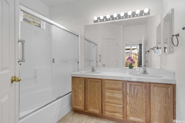 bathroom with vanity and bath / shower combo with glass door