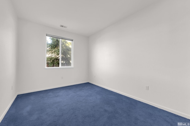 empty room featuring dark colored carpet