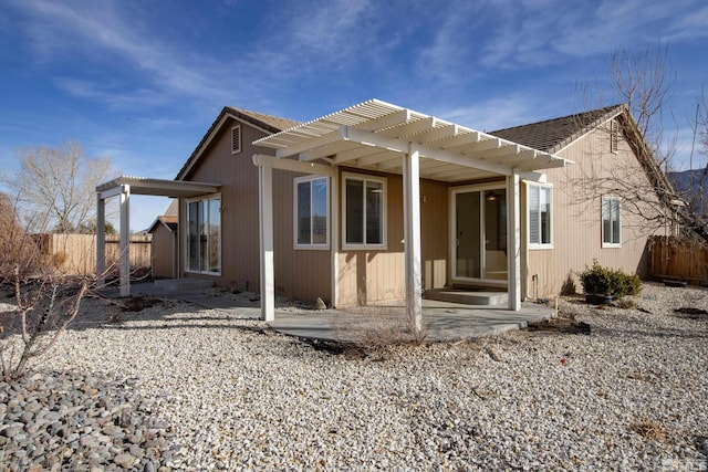 back of house with a pergola and a patio