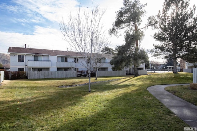 view of home's community with a lawn