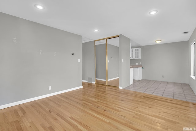 spare room with light hardwood / wood-style flooring