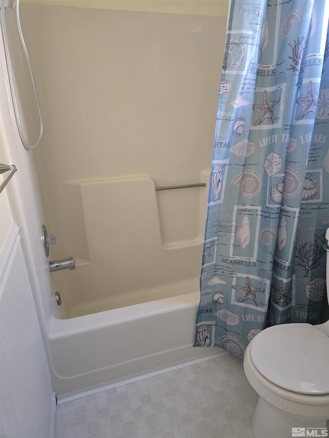 bathroom with shower / bath combination with curtain, toilet, and tile patterned floors