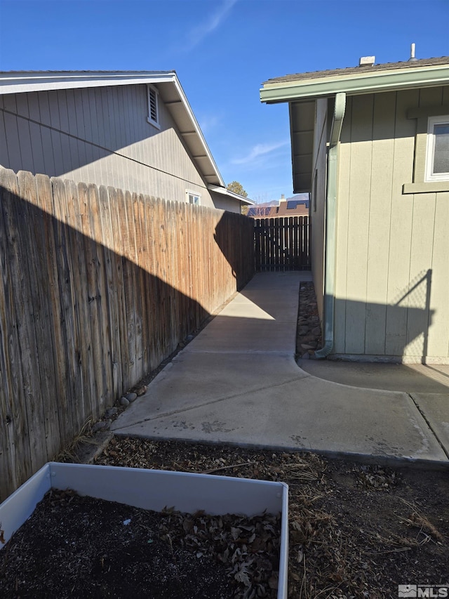 view of side of home featuring a fenced backyard