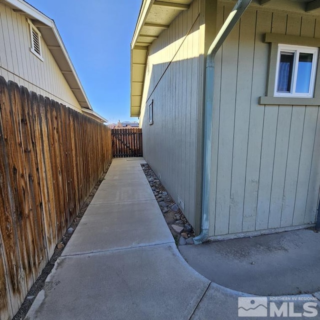 view of side of home featuring fence