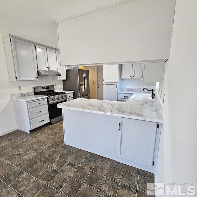 kitchen with light stone counters, stainless steel appliances, a sink, a peninsula, and under cabinet range hood