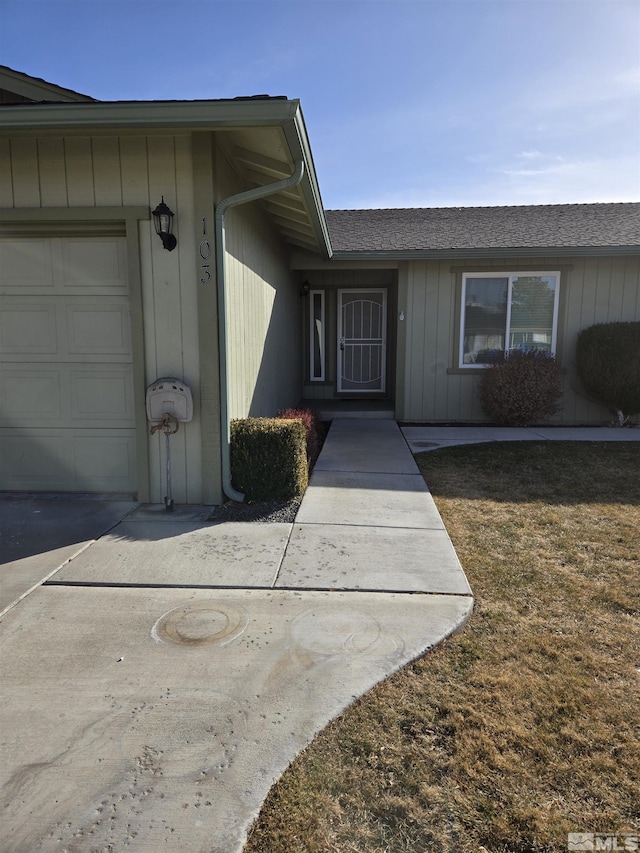 property entrance featuring an attached garage