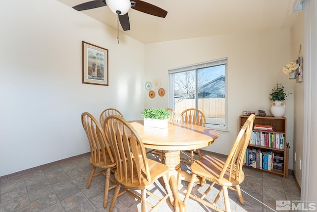 dining room featuring ceiling fan and lofted ceiling