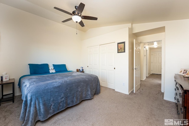 carpeted bedroom featuring a closet, ceiling fan, and lofted ceiling