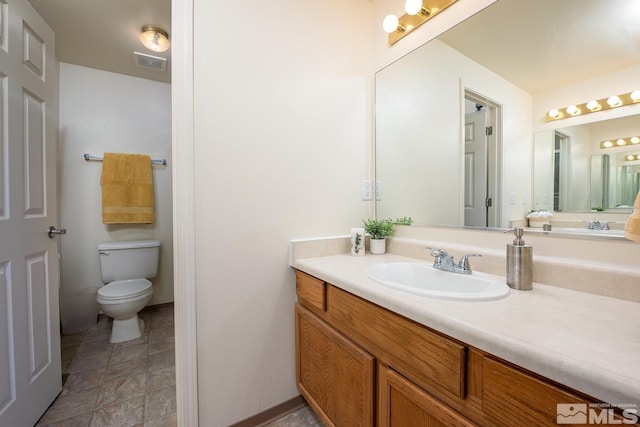 bathroom featuring vanity and toilet